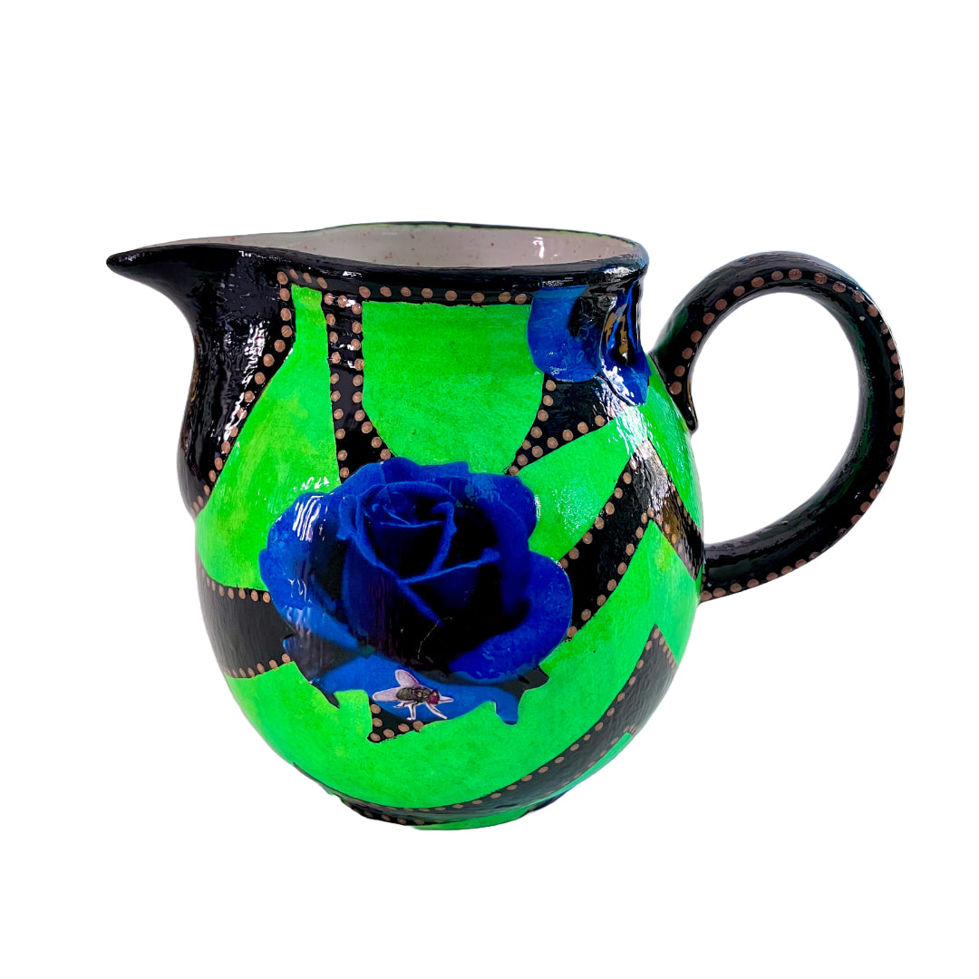 Neon Green upcycled Pitcher/Vase by House of Frisson, featuring some graphics in black and blue roses, beautifully contrasting with the bright green background.