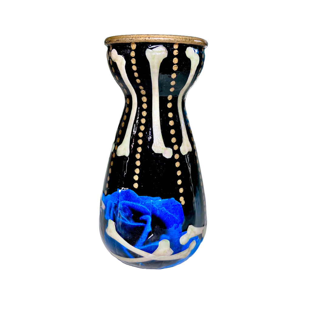 Black Upcycled Glass Bottle/ Vase by House of Frisson, featuring a collage of human bones and blue roses against a black background with some golden dots accent. Quirky and cool.