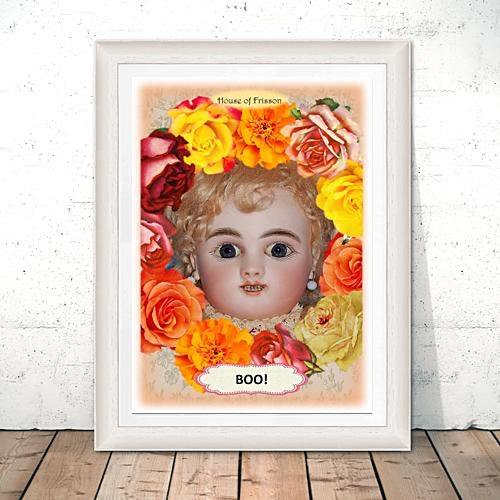 "Boo!" A3 Print by House of Frisson, featuring a vintage doll surrounded by colourful flowers. Print is in a white frame resting on the floor.