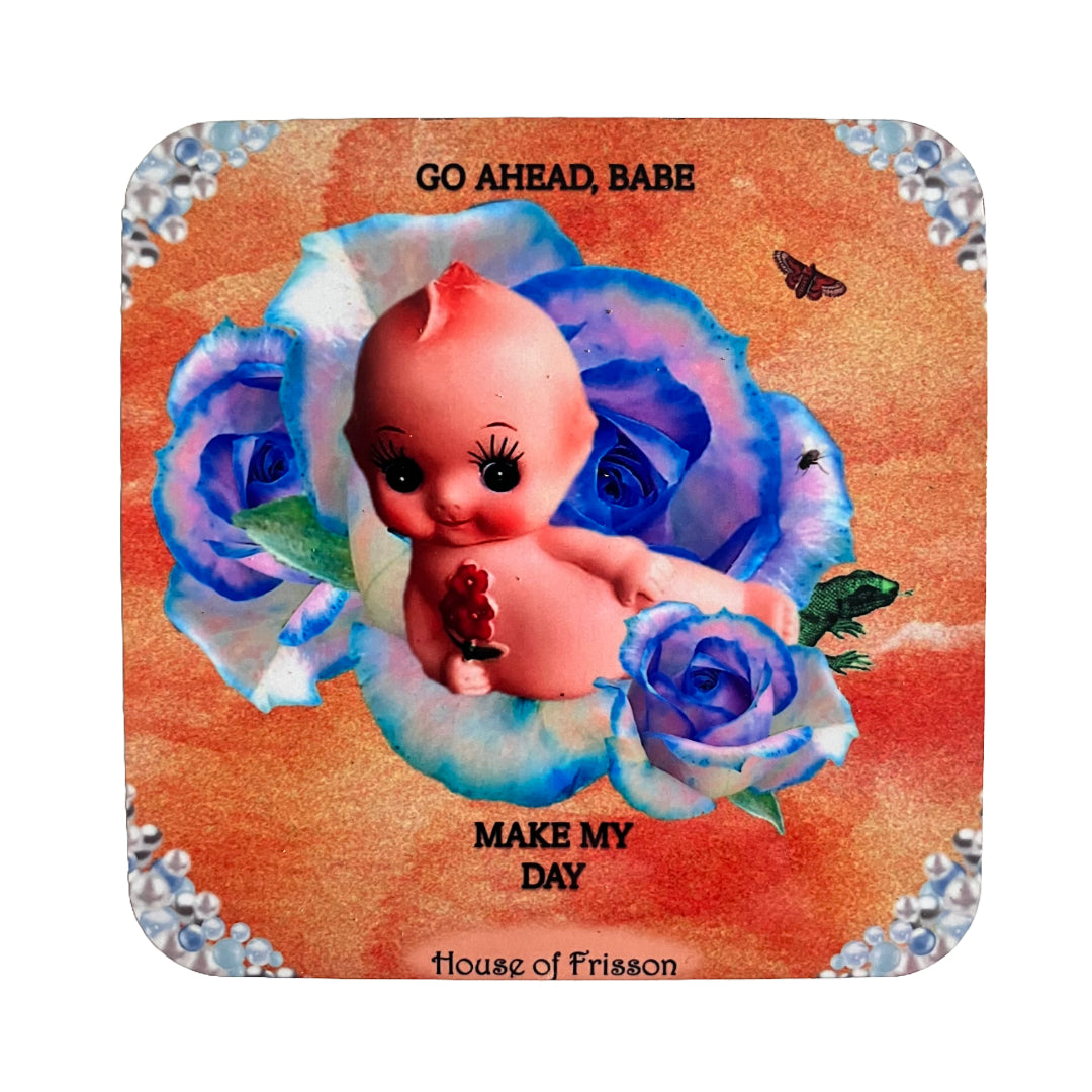 "Go Ahead Babe Make My Day" Coaster by House of Frisson, featuring a doll resting on a blue rose, against an orange background.