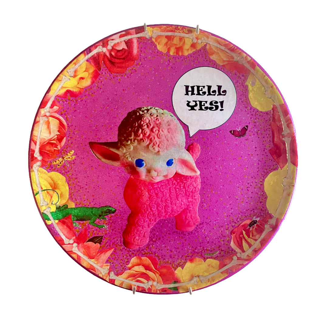 "Hell Yes" Wall Plate by House of Frisson, featuring a collage artwork of a kitsch lamb plastic toy, framed by roses and bones.