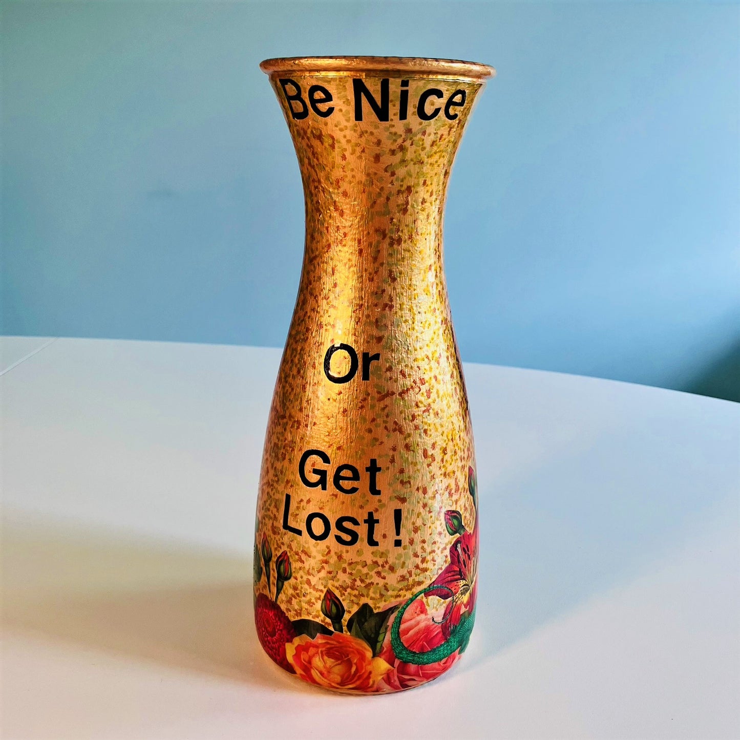 "Be Nice Or Get Lost" Flower Vase by House of Frisson, featuring collage of Queen Elizabeth I with a goat head, on a gold background. Showing back of the vase.