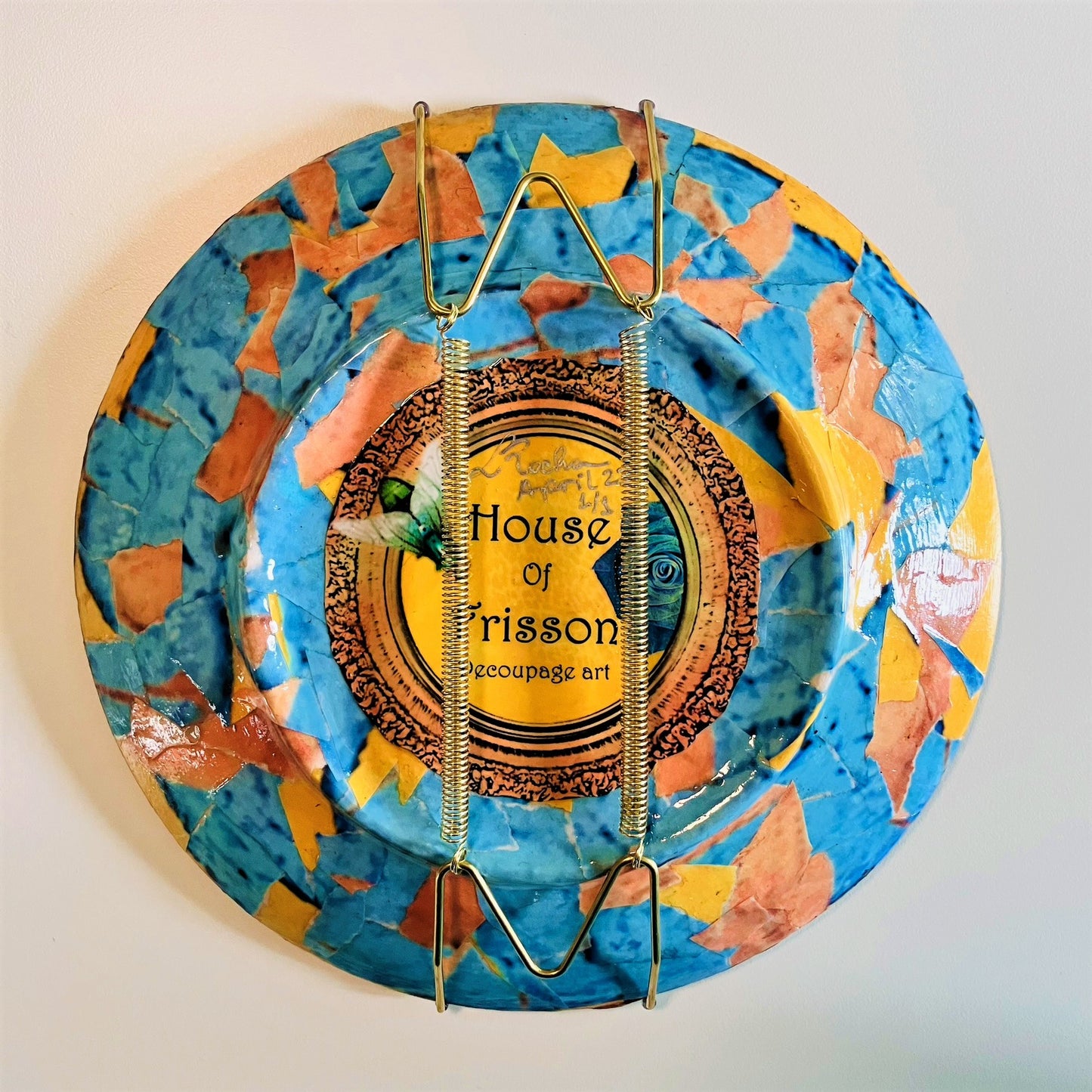 "Blimey" Wall Plate by House of Frisson, featuring a collage of word "blimey" framed with a vintage looking frame, with colourful background. Showing collage on back of the plate, and an attached wall hanger.
