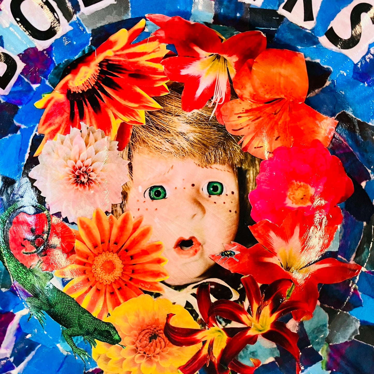 "Bollocks" Wall Plate by House of Frisson, featuring a collage of a vintage male doll surrounded by flowers and a lizard, on a blue background. Closeup details showing the male doll's face among flowers.