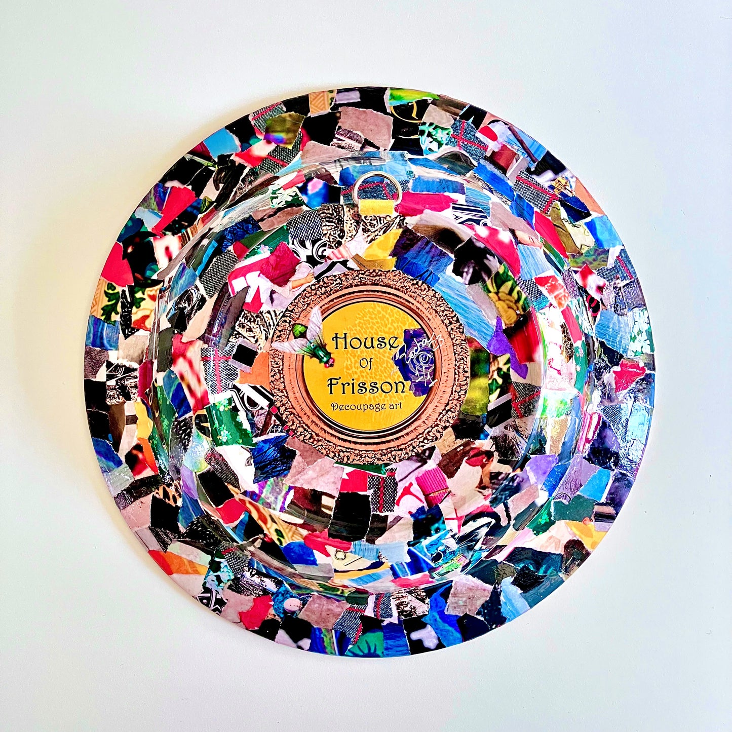 "Resist Fear" Wall Plate by House of Frisson, featuring a female bust statue with "Resist Fear" written across breasts, surrounded by flowers, and pearls, on a purple background. Showing collage on back of the plate.