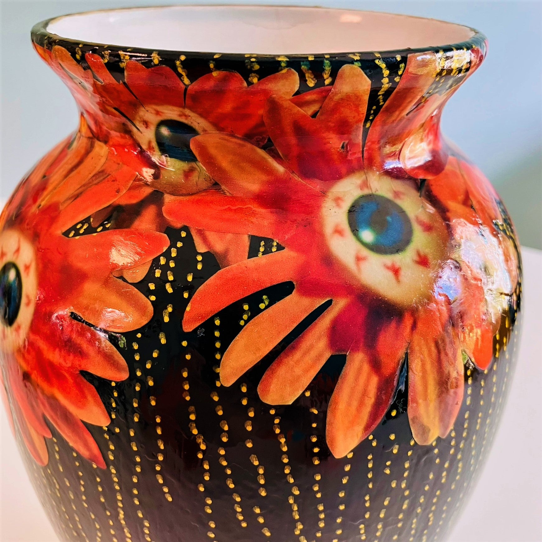 "Starey Flowers" Flower Vase by House of Frisson, featuring a collage of flowers with eyeballs, on a black background. Closeup detail of the flowers.