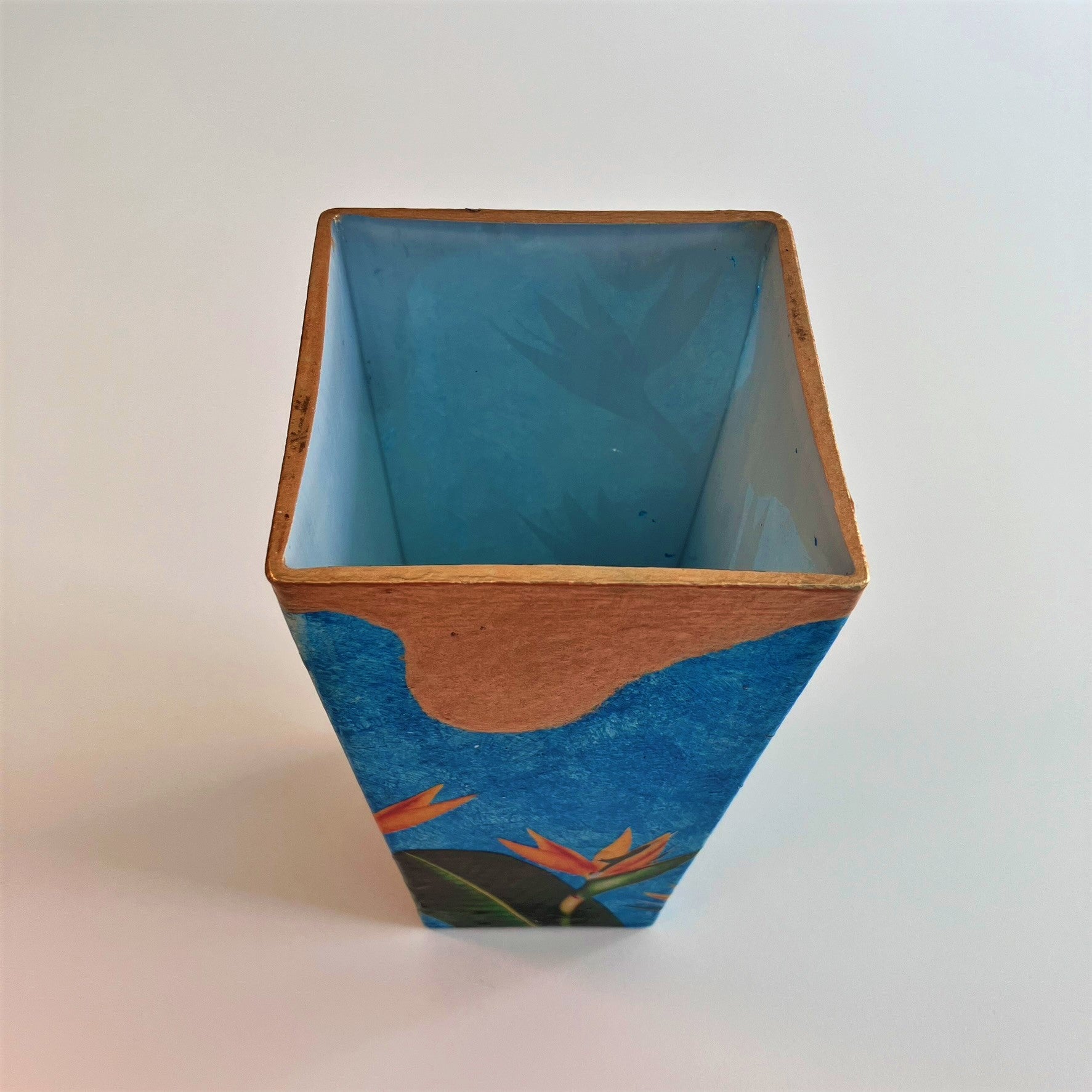 "Strelitzia" Flower Vase by House of Frisson, featuring strelitzia flowers and leaves, on a blue and golden background. Showing inside of the vase.
