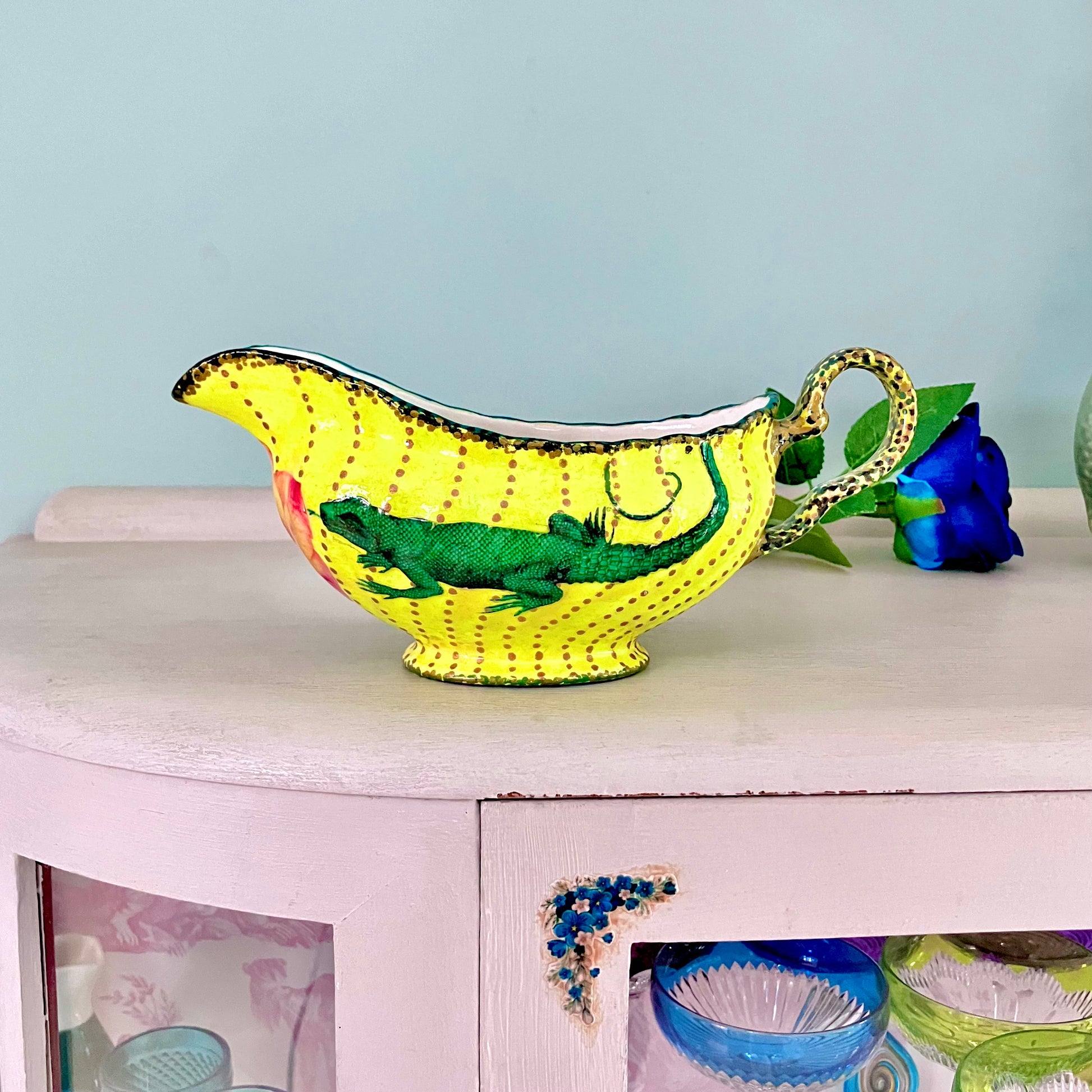 Bright Yellow Upcycled Jug/Vase with a lizard collage design by House of Frisson. Lifestyle photo of the Jug resting on a table.