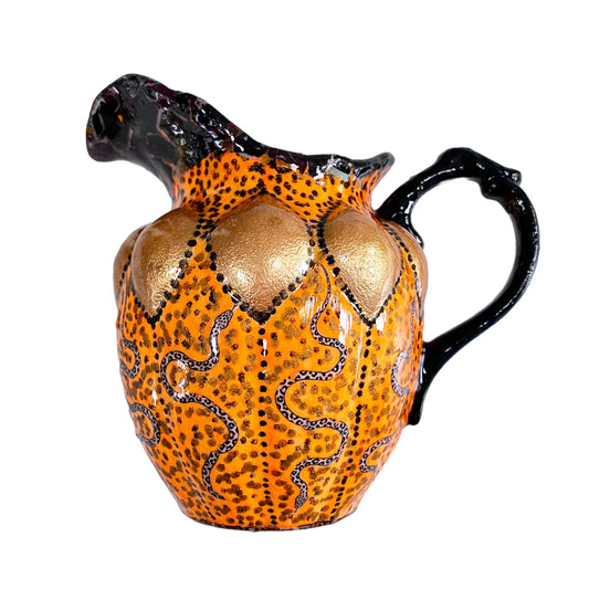 Orange and black upcycled jug/vase by House of Frisson, featuring a collage of snakes against an orange background with black accent.