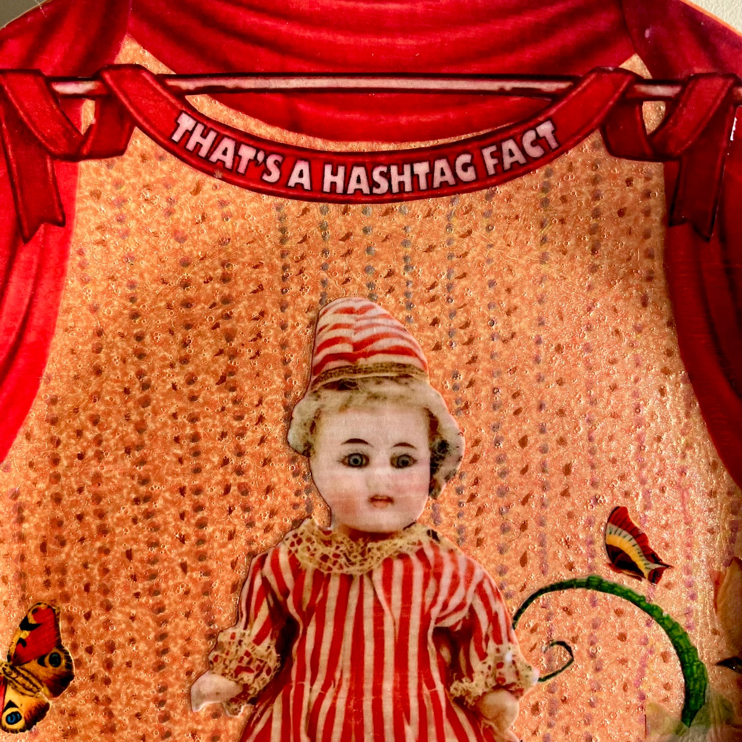 "That's A Hashtag Fact" Wall Plate by House of Frisson, closeup detail of the collage showing a felt doll, and the red curtains.