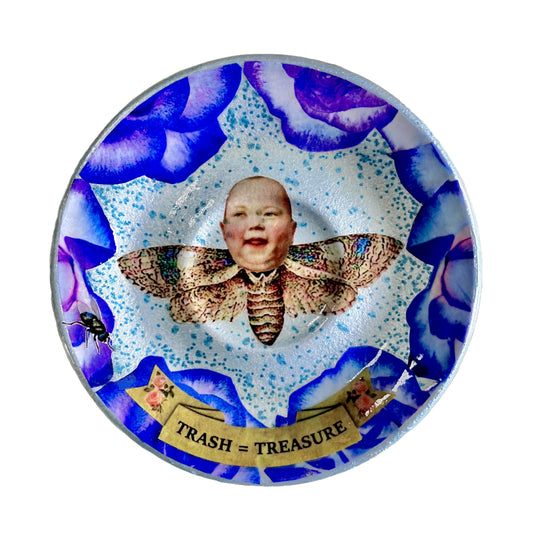 "Trash = Treasure" Trinket Dish by House of Frisson. Featuring a collage of a moth with a doll head, framed with blue roses.