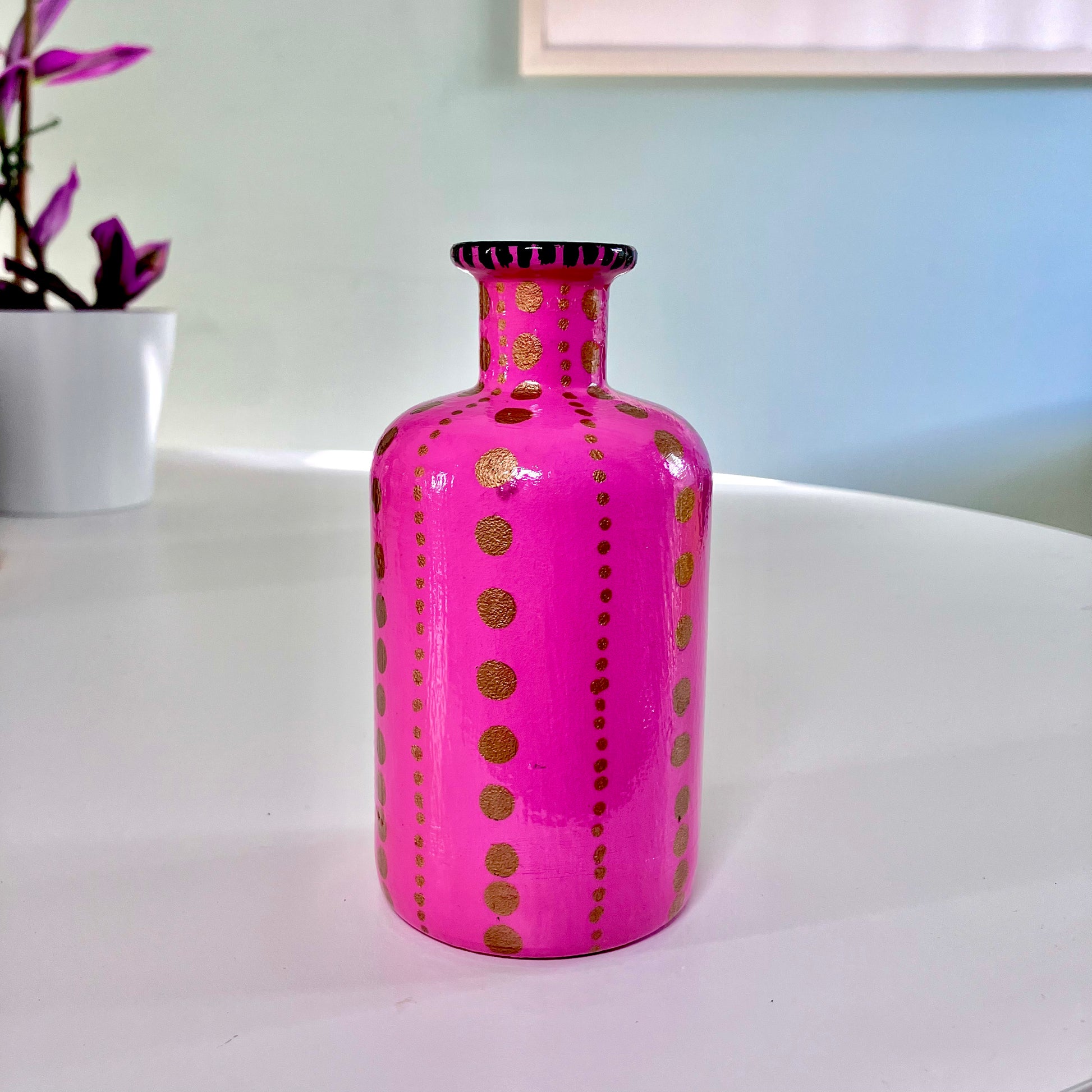 Bright Pink Upcycled Glass Bottle by House of Frisson, featuring an image of a kitsch squeaky lamb toy and some golden dots accent.