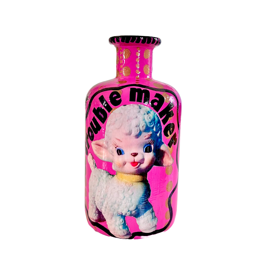 Bright Pink Upcycled Glass Bottle by House of Frisson, featuring an image of a kitsch squeaky lamb toy and some golden dots accent.