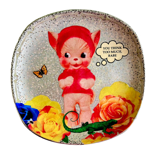 "You Think Too Much, Babe" Silver upcycled wall plate by House of Frisson, featuring a kitsch squeaky toy, some colourful roses and House of Frisson's creatures.