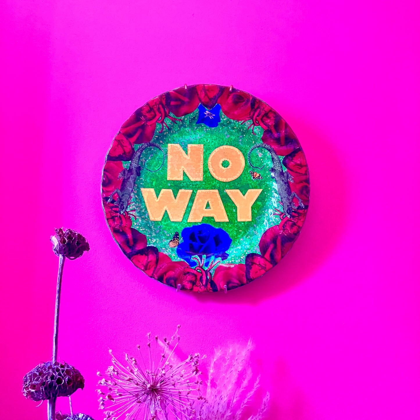 "No Way" one-of-a-kind collage artwork on upcycled wall plate by House of Frisson. Featuring the words "No Way" framed with a collage of roses, and lizards, on a green background. Plate hanging on a pink wall.