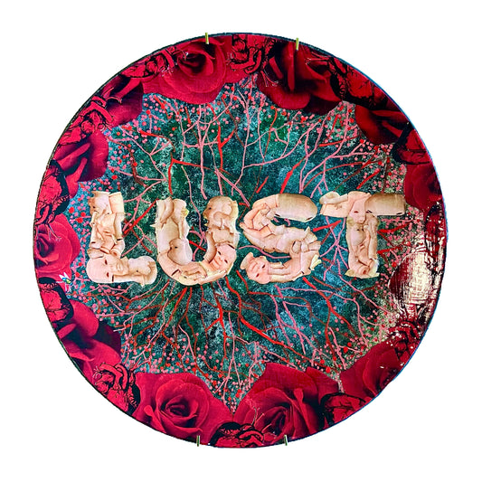 "Lust" Wall Plate by House of Frisson, featuring the word "lust" written with plastic doll parts, framed by red roses and anatomical human heart ,on a charcoal grey background with vein patterns.