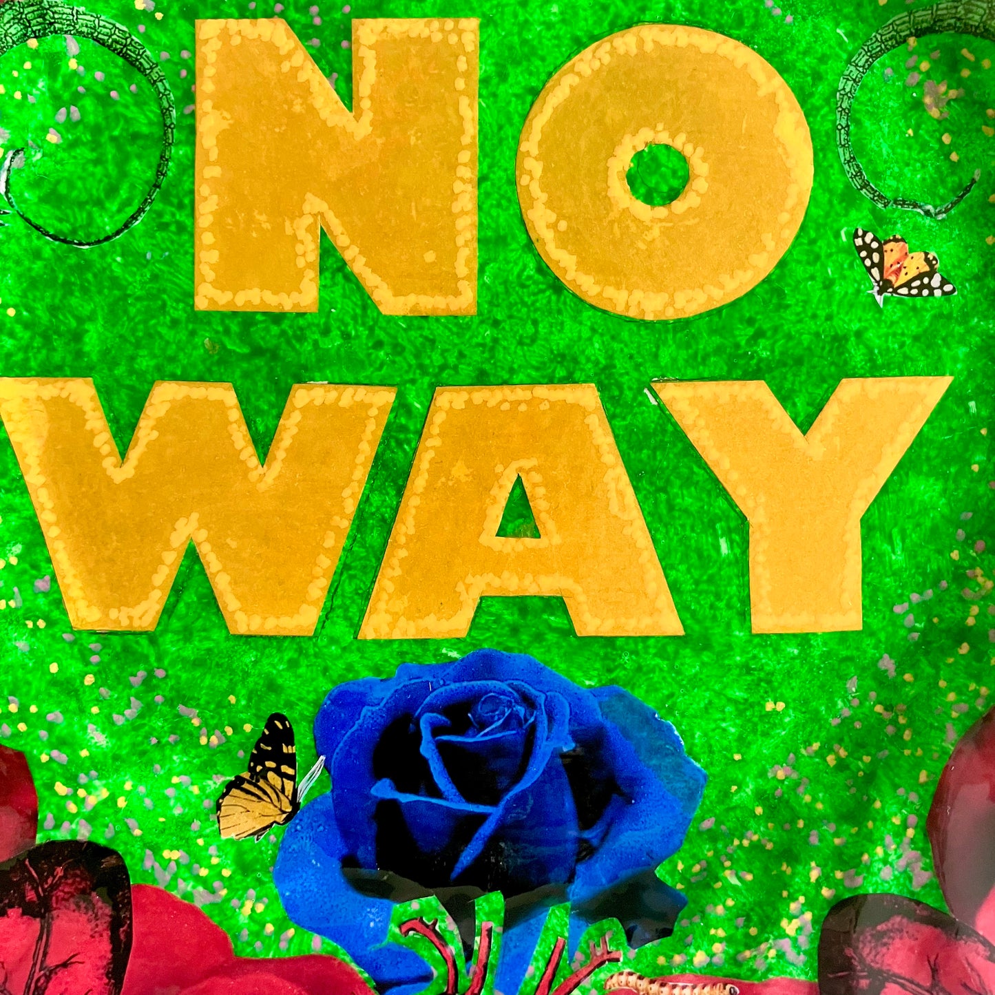 "No Way" one-of-a-kind collage artwork on upcycled wall plate by House of Frisson. Featuring the words "No Way" framed with a collage of roses, and lizards, on a green background. Closeup showing details of the collage.