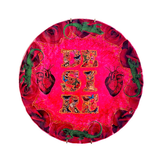 "Desire" Wall Plate by House of Frisson, featuring a collage with the word "desire" written with moths, and a frame of red roses and green lizards, on a hot pink background.