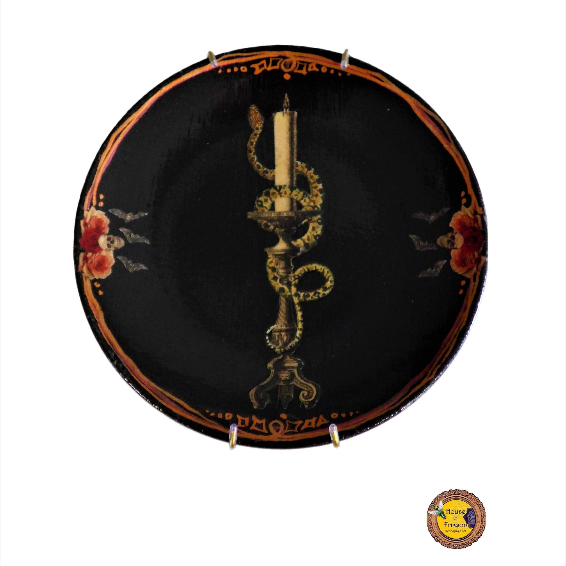 House of Frisson "Snake On Candlestick" Black Wall Plate front. Collage artwork featuring a snake wrapped around a candlestick, with skulls and bats details, on a black background.